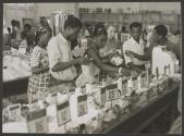 A Department Store in Leopoldville, Belgian Congo maintains the universal policy of " first come, first served."
