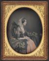 [Woman in profile wearing a cross necklace]