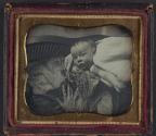 [Baby laying in woman's lap]