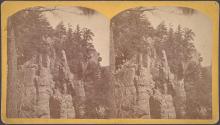 [Rock formations and tree-covered cliffs]