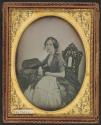 [Woman wearing a cross necklace]