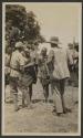 Pat Ayre holding parley with natives concering elephants, African Safari