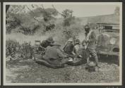 George Eastman and companions dining beside automobile, African Safari