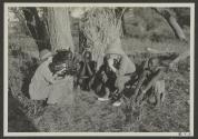 George Eastman and native tribesmen watching Osa Johnson use phonograph, African Safari