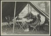 George Eastman and companions around table in tent, African Safari