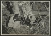 George Eastman and native tribesmen watching Osa Johnson use phonograph, African Safari