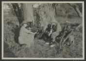 George Eastman and native tribesmen watching Osa Johnson use phonograph, African Safari