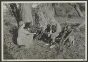 George Eastman and native tribesmen watching Osa Johnson use phonograph, African Safari