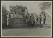 George Eastman and native villagers near Kodok sign, African Safari