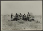 The Johnsons and native hunters beside dead elephant, African Safari