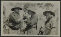 Albert Kaiser lighting cigarette for George Eastman, Osa Johnson beside them, African Safari