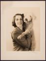 [Woman holding dog]
