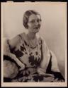 [Woman wearing pearls]