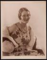 [Woman wearing pearls]