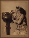 [Woman in jeweled costume with snake]