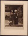 [Two women standing on porch]