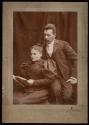 [Woman and man looking at periodical]
