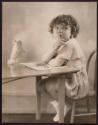 [Child sitting at desk]