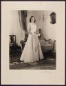 [Standing woman holding bouquet]