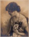 [Woman holding flowers]