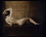[Reclining nude woman on table]