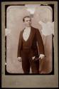 [Elias Goldensky in formal attire]