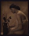 [Woman with vase of flowers]