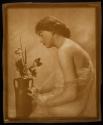 [Woman with vase of flowers]