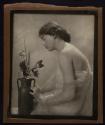 [Woman with vase of flowers]