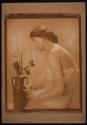 [Woman with vase of flowers]
