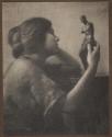 [Woman holding statuette]