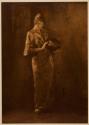 [Woman holding urn]