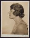 [Woman wearing pearls]