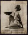 [Woman holding bowl]