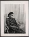 [Woman seated by window]
