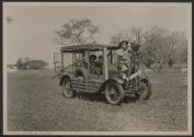 Johnsons operating automobile with mounted motion picture camera, African Safari