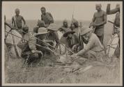 George Eastman and companions examining speared lion, African Safari