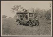 Johnsons in automobile with motion picture camera, African Safari