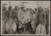 Johnsons posing with shield and native tribesmen, African Safari