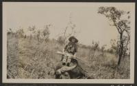 Osa Johnson sitting on dead water buffalo, African Safari