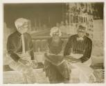 [Martin and Osa Johnson seated with an man]