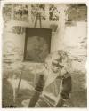 [A woman, likely Osa Johnson, beside her painted portrait]
