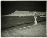 Mr. Johnson on Waikaiki Beach with Diamond Head in the distance.