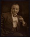 [Man holding cigar]