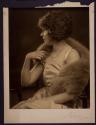 [Woman wearing fur stole]