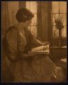 [Seated woman reading book]