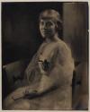 [Woman holding fan]