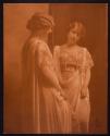 [Woman looking in mirror]