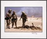 Three U.S. soldiers look over the burnt corpse of an Iraqi soldier before burying it on the day after the Gulf War ended, Kuwait