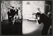 [Man taking picture of a family]